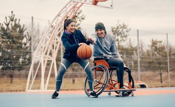 2 basketball players, one is in a wheelchair